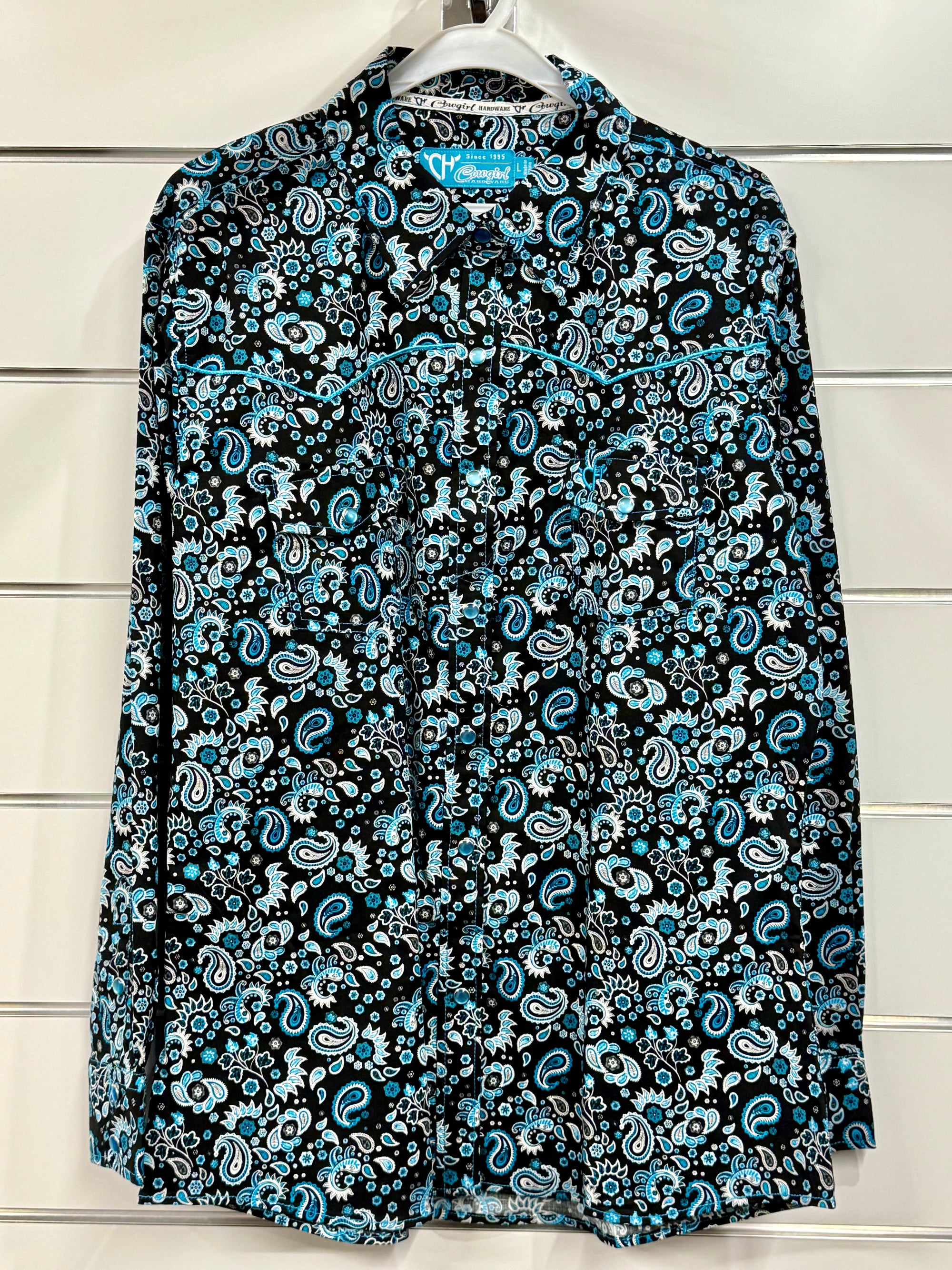 Blue and black paisley patterned shirt on a hanger against a white background